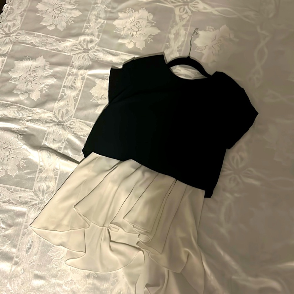 Black tee with a flowey white bottom.